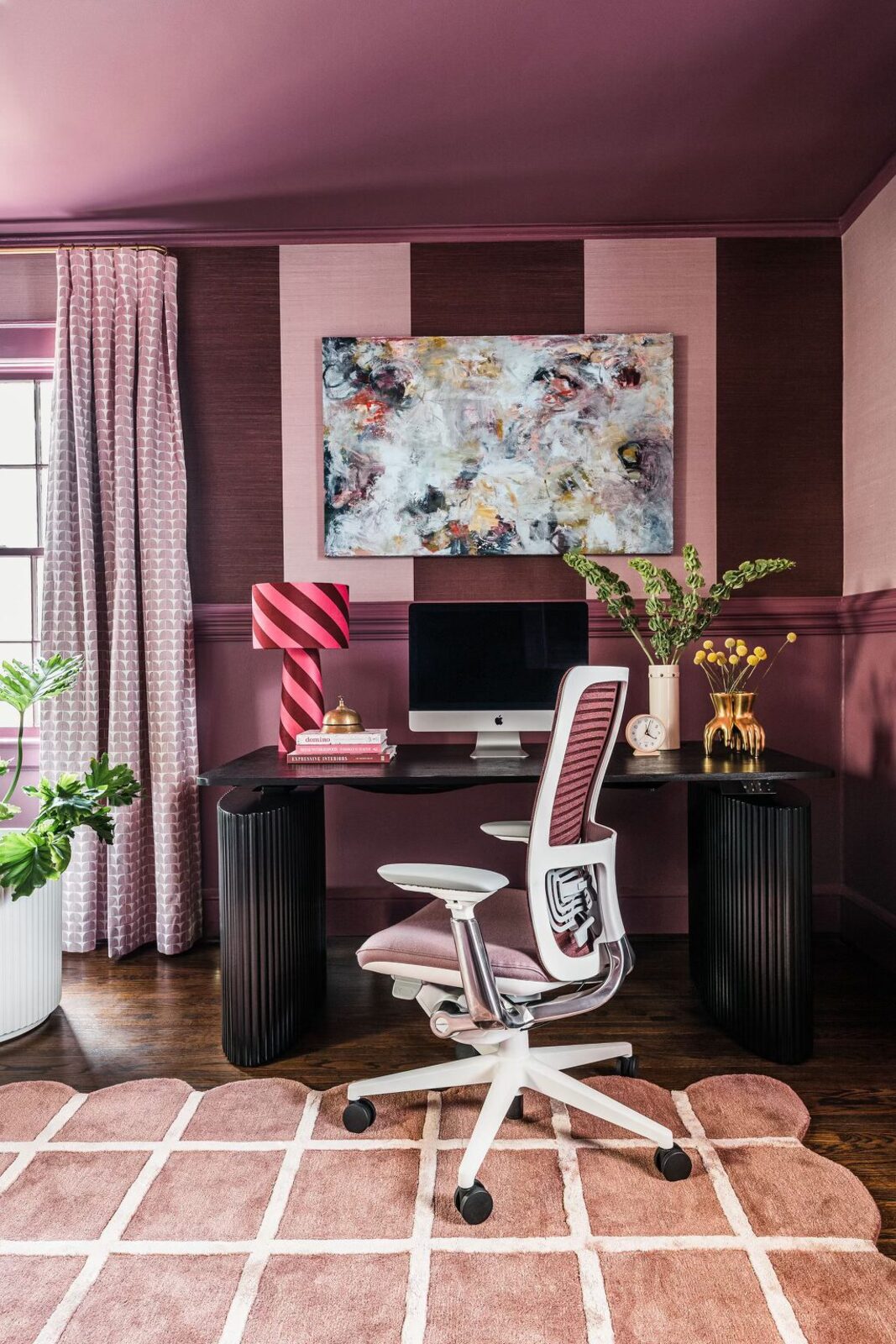Moody plum room styled with an original abstract canvas